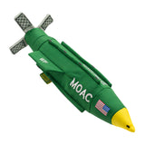 an image of the Carbon Hound MOAC dog toy which is a scale replica of the MOAB military bomb, standing upright on its base. the toy is green, yellow and white with the word MOAC embroidered on the side, with an American flag on the nose cone