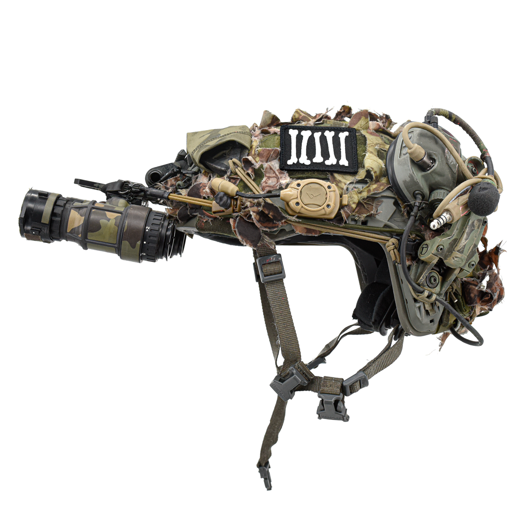 carbon hound rebel bones embroidered patch shown on a tactical camo helmet with night vision and devices and ear protection