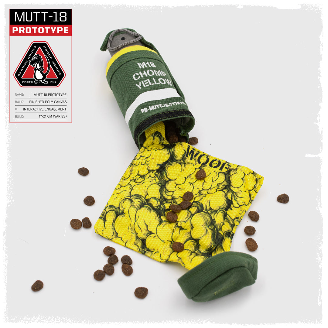 close up of carbon hound Mutt-18 M18 smoke grenade dog toys with treat cavity open showing dog treats in heavy canvas for aggressive chewers